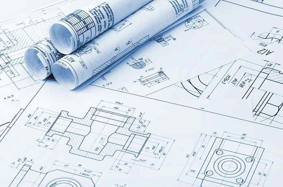 Rolled engineering blueprints and technical mechanical drawings spread out on a flat surface, showing dimensional specifications and component details